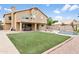A spacious backyard with a pool, grassy area, covered patio, and basketball court for recreation at 3126 W Stephens Pl, Chandler, AZ 85226
