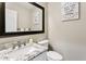 Updated powder room features modern fixtures, granite countertop and funny wall art at 3126 W Stephens Pl, Chandler, AZ 85226