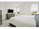 Spacious bedroom featuring modern furnishings, TV, and arched windows at 3126 W Stephens Pl, Chandler, AZ 85226