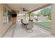 An outdoor covered patio with a ceiling fan, furniture, a mounted television, and a view of the backyard at 3126 W Stephens Pl, Chandler, AZ 85226