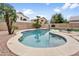 A kidney shaped pool with a basketball hoop, lounge chair, and manicured landscaping in the backyard at 3126 W Stephens Pl, Chandler, AZ 85226