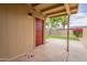 Cozy covered patio overlooks backyard with lush landscaping at 3620 E Ludlow Dr, Phoenix, AZ 85032
