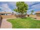 The backyard is landscaped with a lush lawn and a walkway of decorative gravel at 3620 E Ludlow Dr, Phoenix, AZ 85032