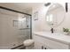 Updated bathroom with new vanity, fixtures, and a glass-enclosed tiled shower at 3620 E Ludlow Dr, Phoenix, AZ 85032