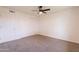 Spacious bedroom with new carpet, neutral paint, a ceiling fan and closet space at 3620 E Ludlow Dr, Phoenix, AZ 85032