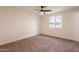 Bedroom with neutral paint, updated ceiling fan, and plush carpet at 3620 E Ludlow Dr, Phoenix, AZ 85032