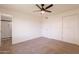 Bedroom with neutral paint, a ceiling fan, plush carpet, and an ensuite bathroom at 3620 E Ludlow Dr, Phoenix, AZ 85032