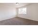 An empty carpeted bedroom with natural light from a window at 3620 E Ludlow Dr, Phoenix, AZ 85032