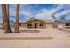 View of a single-story home with desert landscaping, palm trees and attached garage at 3620 E Ludlow Dr, Phoenix, AZ 85032