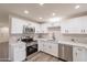 New kitchen featuring white cabinets, stainless steel appliances, a subway backsplash, and light stone countertops at 3620 E Ludlow Dr, Phoenix, AZ 85032