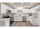 New kitchen featuring white cabinets, stainless steel appliances, a subway backsplash, and light stone countertops at 3620 E Ludlow Dr, Phoenix, AZ 85032
