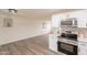 Open layout with new kitchen featuring stainless steel appliances and white cabinets overlooking the living area at 3620 E Ludlow Dr, Phoenix, AZ 85032