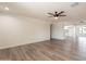 Inviting living room with wood-look floors leading into the updated kitchen with white cabinets at 3620 E Ludlow Dr, Phoenix, AZ 85032