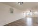Bright living room with stylish flooring and white walls flowing towards a front door and window at 3620 E Ludlow Dr, Phoenix, AZ 85032