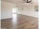 Spacious living room with light-colored wood-look floors flowing to the dining area and fresh paint at 3620 E Ludlow Dr, Phoenix, AZ 85032