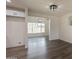 Bright living room featuring gray wood floors, light gray walls, modern lighting, and a glimpse of the backyard at 3620 E Ludlow Dr, Phoenix, AZ 85032