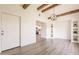 Bright living room with wood beam accents, recessed shelving, and light, wood-look floors at 3620 E Ludlow Dr, Phoenix, AZ 85032