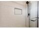 Modern shower features sleek tile, a built-in niche, and a frameless glass door at 3620 E Ludlow Dr, Phoenix, AZ 85032