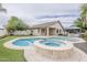 A backyard oasis featuring a beautiful pool, a spa, gazebo, and lush landscaping for ultimate relaxation at 4067 S White Dr, Chandler, AZ 85249