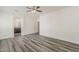 Neutral bedroom with wood-look floors and an ensuite bath and walk-in closet at 4067 S White Dr, Chandler, AZ 85249