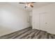 Comfortable bedroom with wood-look floors and a closet with sliding doors at 4067 S White Dr, Chandler, AZ 85249