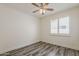 A well-lit bedroom with a ceiling fan and shuttered windows at 4067 S White Dr, Chandler, AZ 85249
