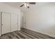 Comfortable bedroom with wood-look floors and a closet with sliding doors at 4067 S White Dr, Chandler, AZ 85249