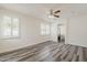 Comfortable bedroom with wood-look flooring, plantation shutters, and ensuite bath at 4067 S White Dr, Chandler, AZ 85249