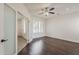 Bedroom with hardwood floors, fan, plantation shutters, and frosted french doors at 4067 S White Dr, Chandler, AZ 85249