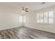 Bright, spacious bedroom with wood-look floors, plantation shutters, and ample natural light at 4067 S White Dr, Chandler, AZ 85249