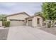 Single-story home featuring a two-car garage, desert landscaping, and a neutral color scheme at 4067 S White Dr, Chandler, AZ 85249