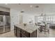 Kitchen with island, granite countertops, dark wood cabinets, and stainless refrigerator at 4067 S White Dr, Chandler, AZ 85249