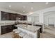 Kitchen with large island, granite countertops, dark wood cabinets and stainless appliances at 4067 S White Dr, Chandler, AZ 85249
