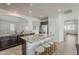 Kitchen with island, granite countertops, dark wood cabinets and stainless refrigerator at 4067 S White Dr, Chandler, AZ 85249