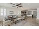 Open floor plan with views to the kitchen, featuring tile floors, gray sofa, and natural light at 4067 S White Dr, Chandler, AZ 85249