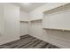 Walk-in closet with wood-look floors and open shelving at 4067 S White Dr, Chandler, AZ 85249
