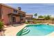 Inviting backyard pool featuring a tanning shelf and lush landscaping at 4114 E Muirwood Dr, Phoenix, AZ 85048