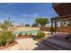 Charming pool featuring a baja step, desert landscaping, and an elevated patio at 4114 E Muirwood Dr, Phoenix, AZ 85048