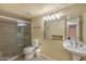 Functional bathroom featuring a stand-up shower, toilet, and a pedestal sink at 4114 E Muirwood Dr, Phoenix, AZ 85048