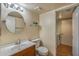 Bathroom featuring a wood vanity, tile flooring, updated fixtures, and access to the laundry room at 4114 E Muirwood Dr, Phoenix, AZ 85048