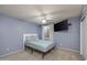 Cozy bedroom with a ceiling fan, carpeted floor, and a wall-mounted television at 4114 E Muirwood Dr, Phoenix, AZ 85048