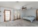Bedroom with carpeted flooring, a ceiling fan, and a door to the outside at 4114 E Muirwood Dr, Phoenix, AZ 85048