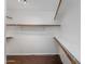 Spacious walk-in closet with shelving and wooden rods for optimal organization at 4114 E Muirwood Dr, Phoenix, AZ 85048