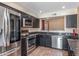 Well-equipped kitchen with stainless steel appliances and dark cabinetry at 4114 E Muirwood Dr, Phoenix, AZ 85048