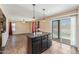 Stylish kitchen island with dark cabinets and a granite countertop overlooking the pool at 4114 E Muirwood Dr, Phoenix, AZ 85048