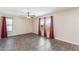 A bright and airy living room with tile floors, a ceiling fan, and large windows at 4114 E Muirwood Dr, Phoenix, AZ 85048