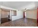 An open living room with tile flooring, a ceiling fan, and a partial partition wall at 4114 E Muirwood Dr, Phoenix, AZ 85048