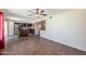 A combined living space featuring tile flooring, an open floor plan, and a view into the kitchen at 4114 E Muirwood Dr, Phoenix, AZ 85048