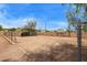 Large, enclosed backyard with parking structure and chain-link fence at 4922 W Fallen Leaf Ln, Glendale, AZ 85310