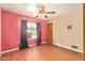 Bedroom with a hardwood floors, ceiling fan, and a window with curtains at 4922 W Fallen Leaf Ln, Glendale, AZ 85310